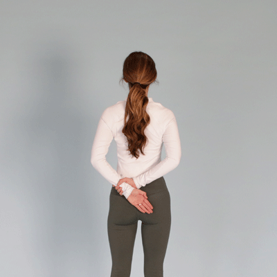 a woman is doing hand behind back stretch