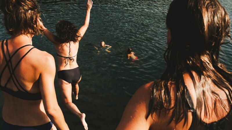 girls jumping into water