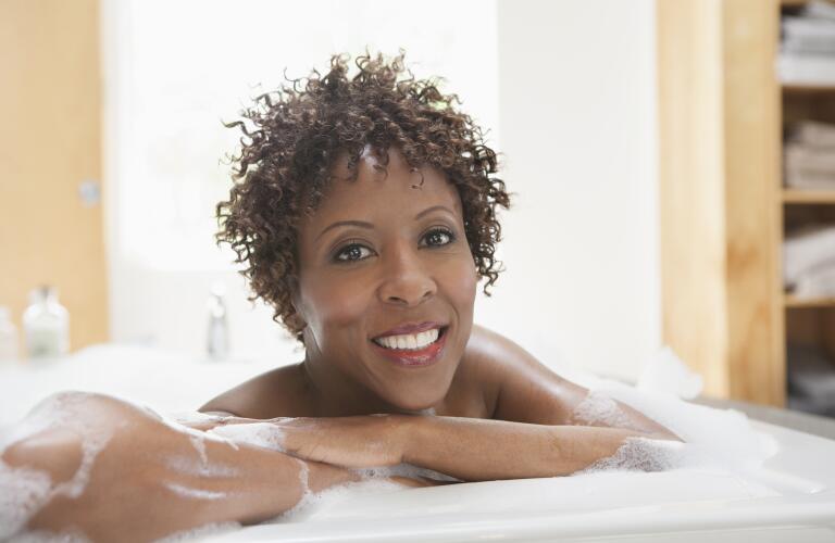 Woman relaxing in bubble bath