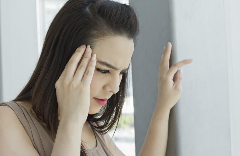 Woman with headache, migraine, stress, insomnia, hangover