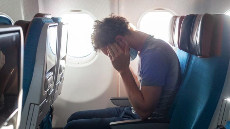 Person sitting and holding their head