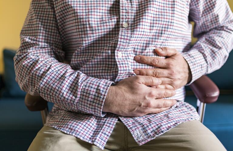 Midsection Of Man Suffering From Stomachache At Home