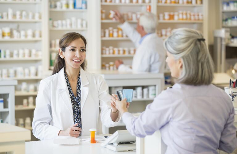 Woman paying with card at pharmacy