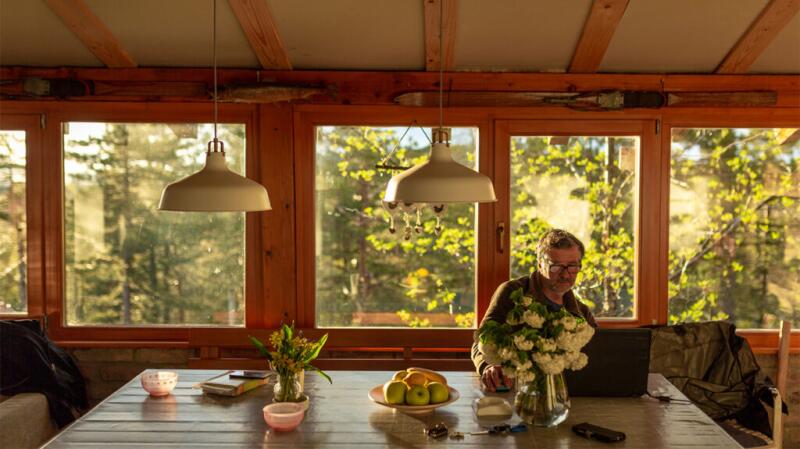 man using a laptop computer at a kitchen table