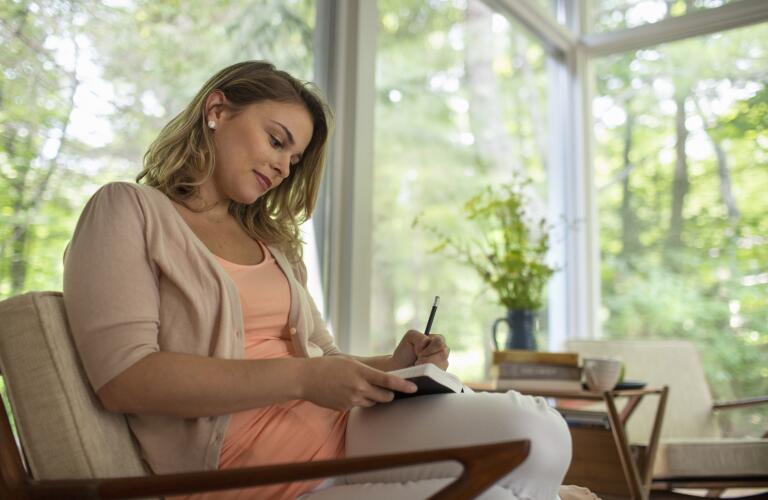 Woman writing in journal