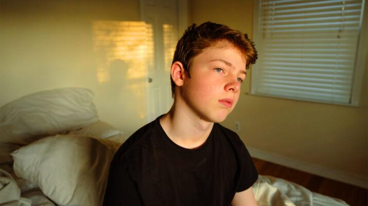 A young man looks pensive.