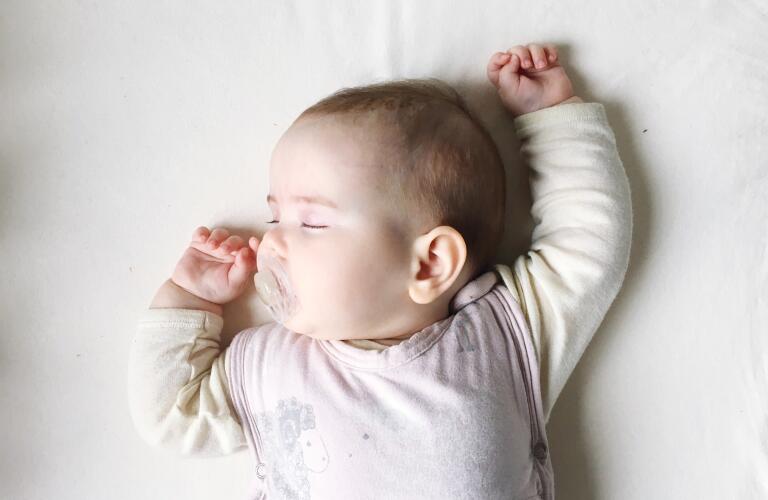 sleeping infant with pacifier