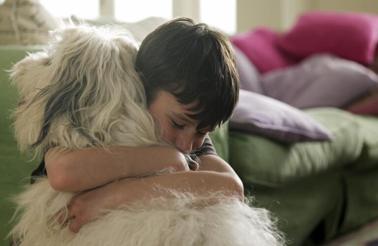 Boy hugging his dog