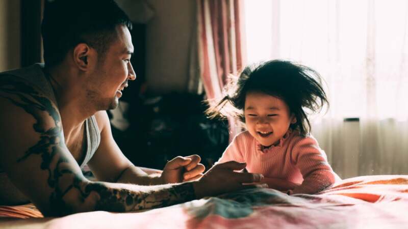 A father playing with his young daughter