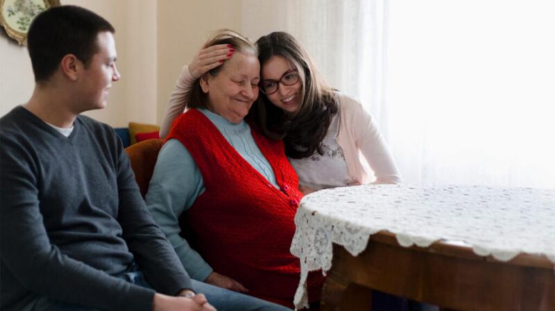 a woman with multiple myeloma is sat with her grandchildren