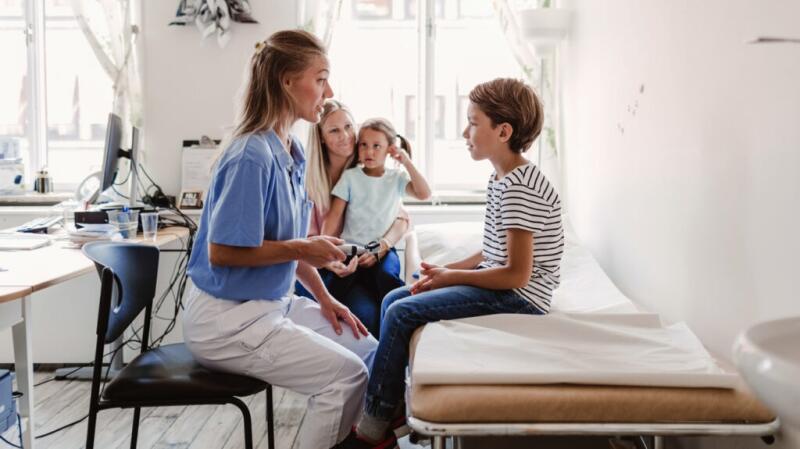 a doctor is talking to a child with adhd