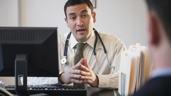 Doctor talking to clients in office