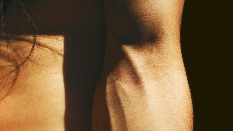 A closeup of prominent veins on a person's inner arm