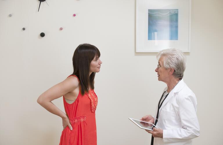 young female patient talking with senior female doctor