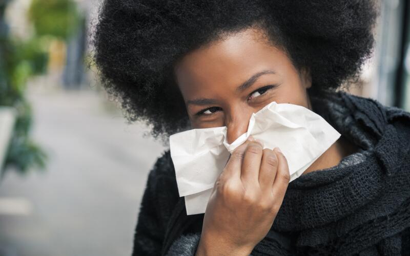 woman-on-street-sneezing