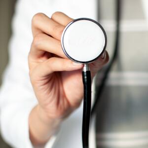 female doctor holding up stethoscope