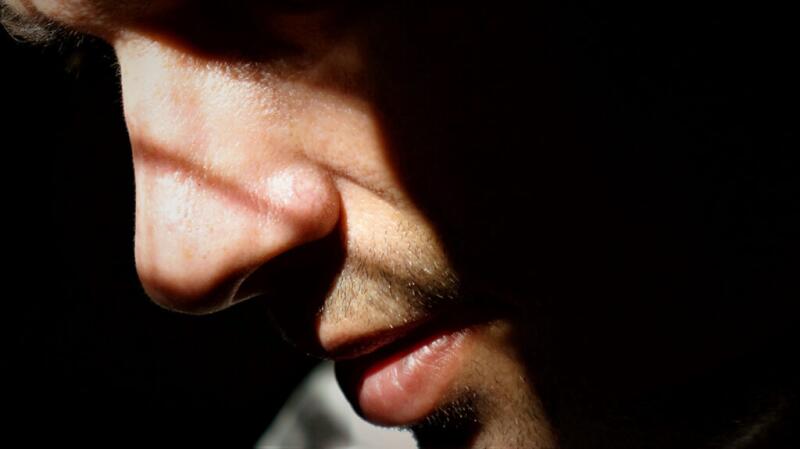 A close-up image of a person's nose in direct sunlight.