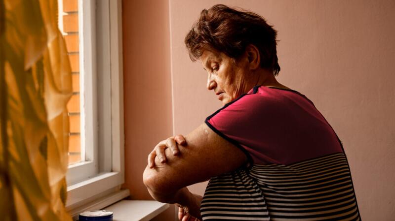 woman looking at her arm