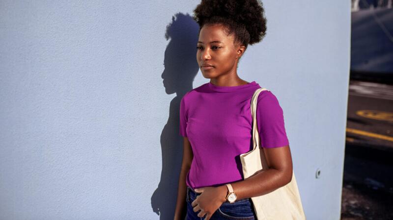 a woman is walking with her hand on her stomach