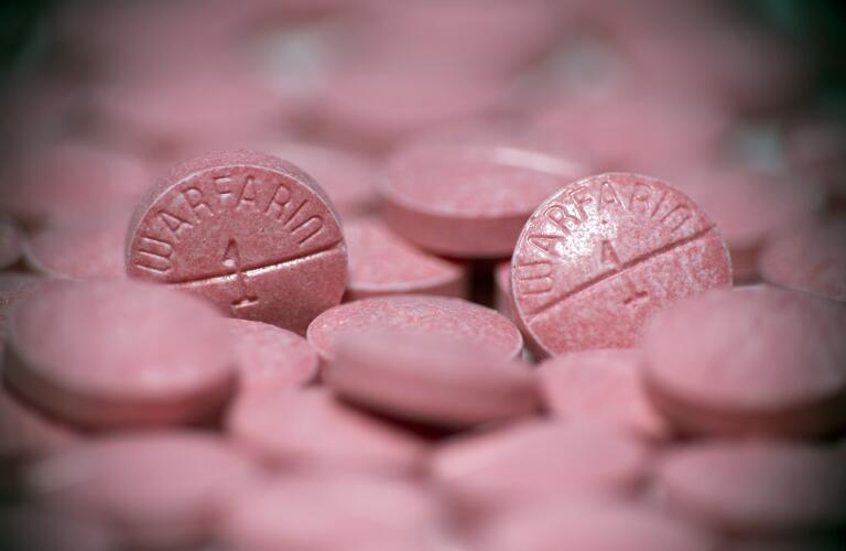 Close-up of Warfarin blood thinner anticoagulant pills on larger pile