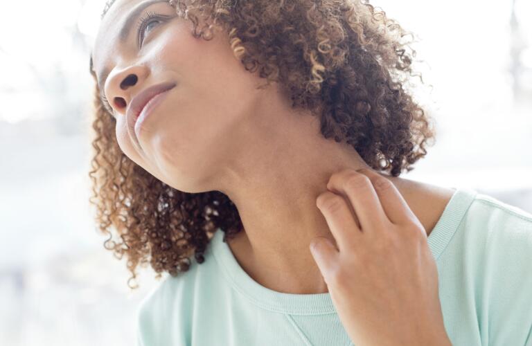 woman scratching neck