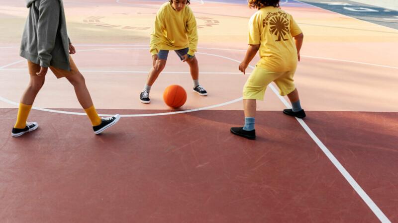 Cropped image of young kids playing basketball