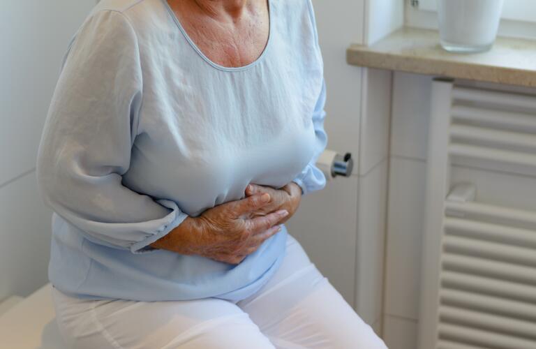 midsection of senior woman suffering from stomachache