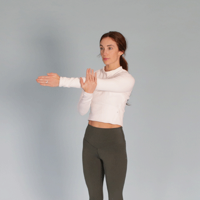a woman is doing a shoulder stretch
