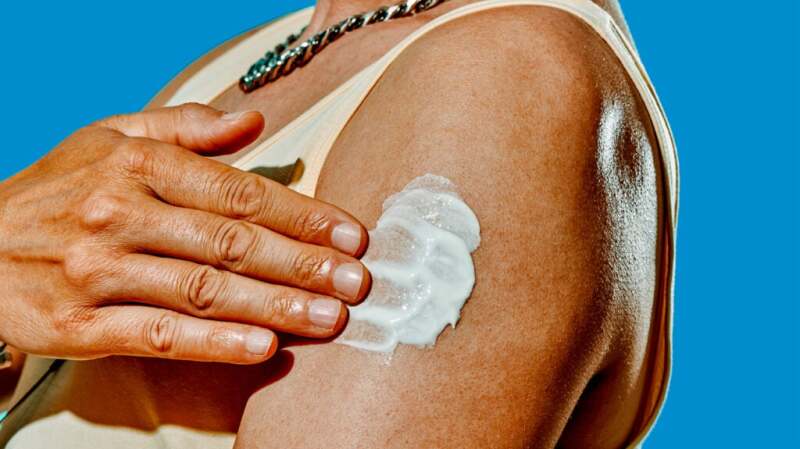 A person is moisturizing their arm.