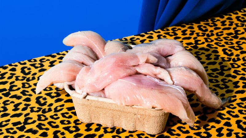 There is a basket of raw chicken.