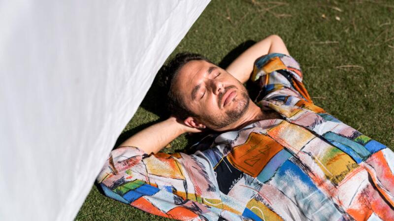 A man laying in the sun