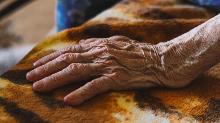 There is a closeup of a wrinkly hand.