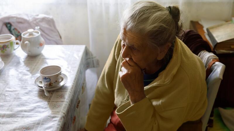 An older woman thinking