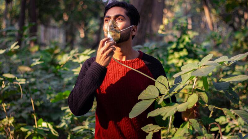 Person using an oxygen mask outdoors