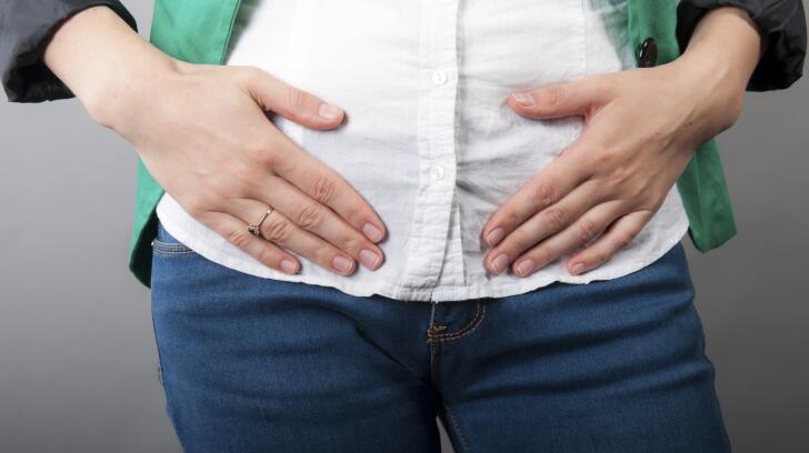 closeup of woman holding stomach