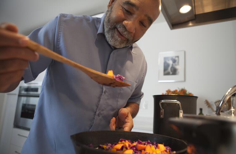 man cooking food on stove