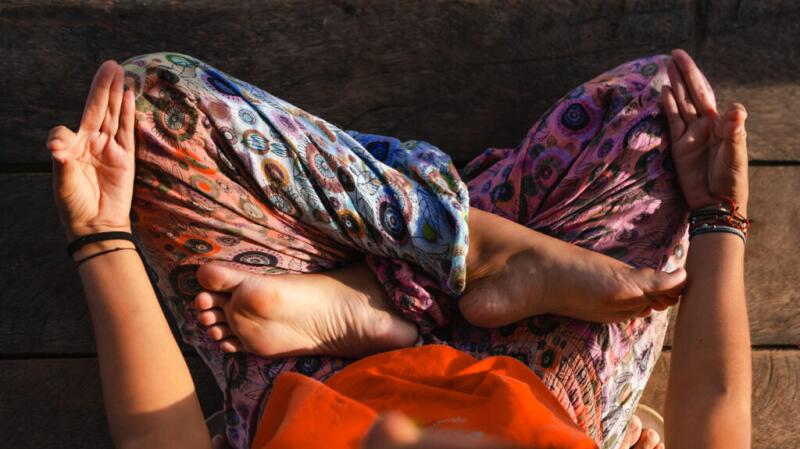 An overhead shot of a woman sitting and meditating