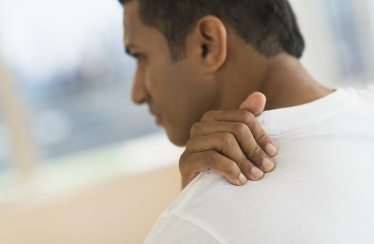 man-massaging-shoulder