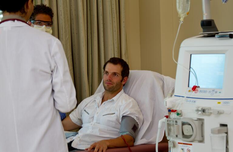 Renal dialysis male patient has care review with doctor and nurse