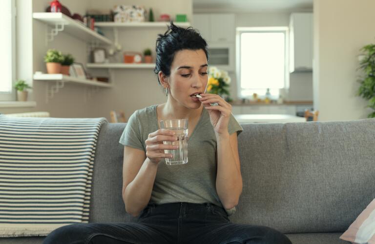Young Woman Taking a Pill
