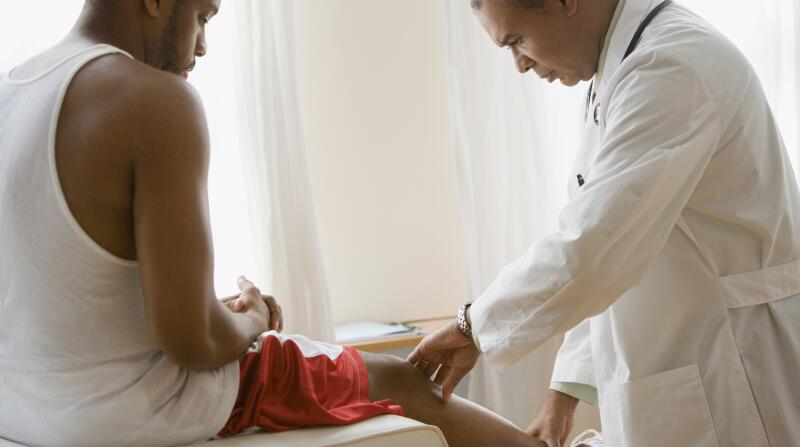 Man has leg examined by doctor