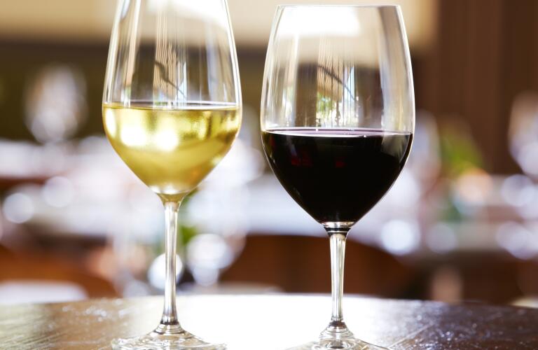 glasses of red and white wine on table