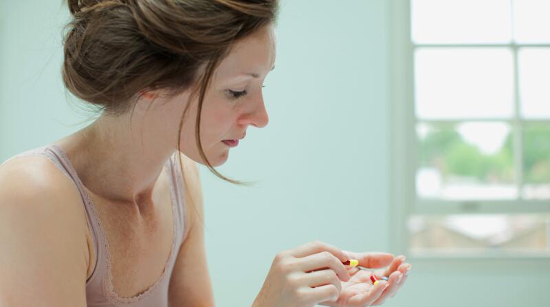 woman holding pills
