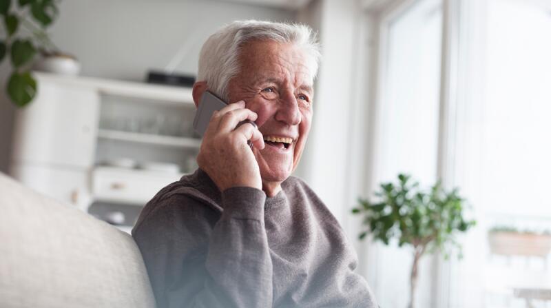 senior-man-telephoning-with-smart-phone-at-home