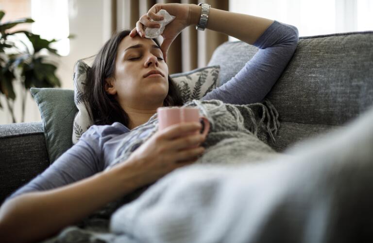 Sick woman lying in bed