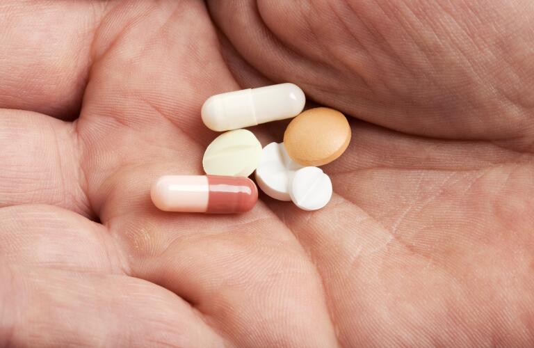 variety-of-pills-in-hand