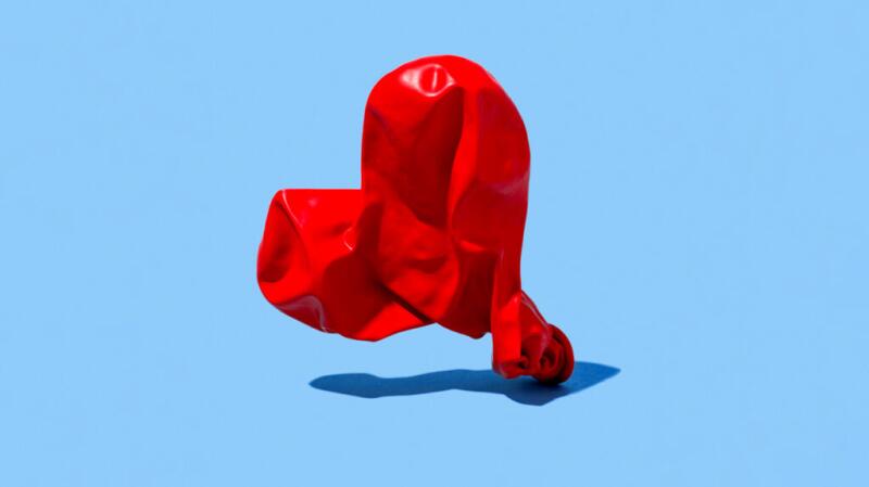 There is a deflated balloon in the shape of a heart.