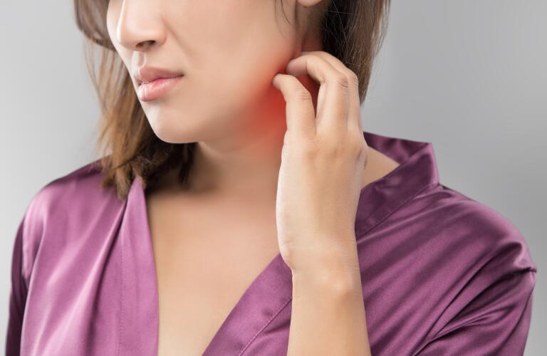 woman scratching neck