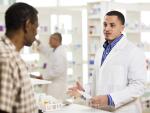 African American male pharmacist talking to African American male customer about prescription
