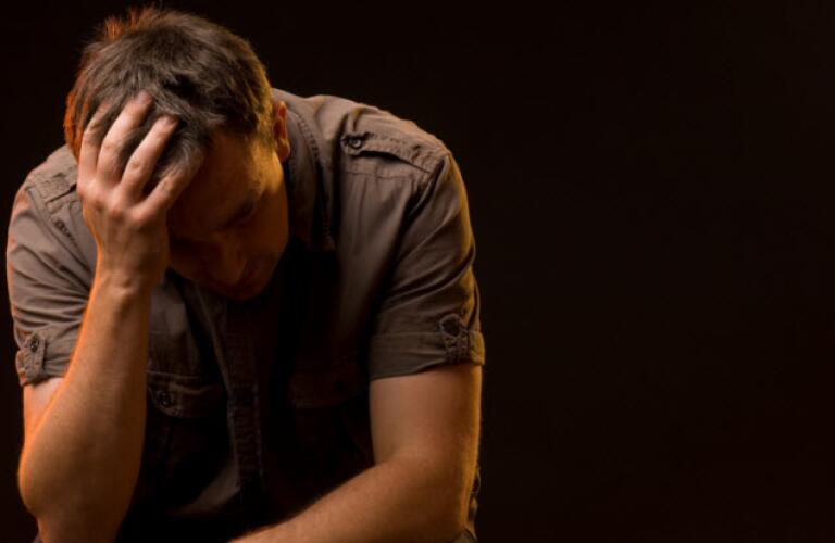 man with his head in his hands